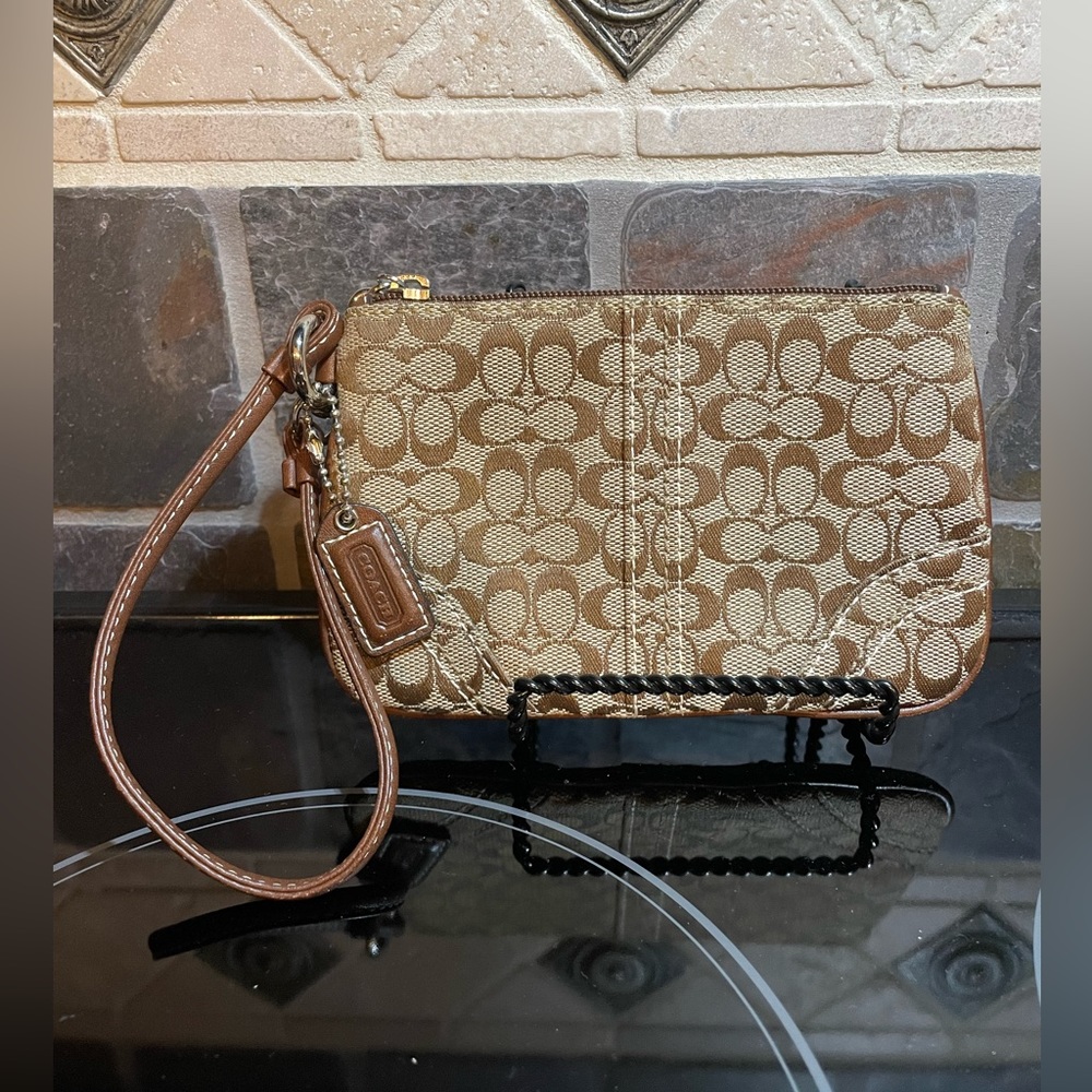Coach Wristlet Monogram C cloth with brown  inside vintage like new condition